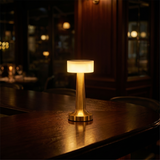 Cordless LED Bar Table Lamp glowing on a dark restaurant bar table at night